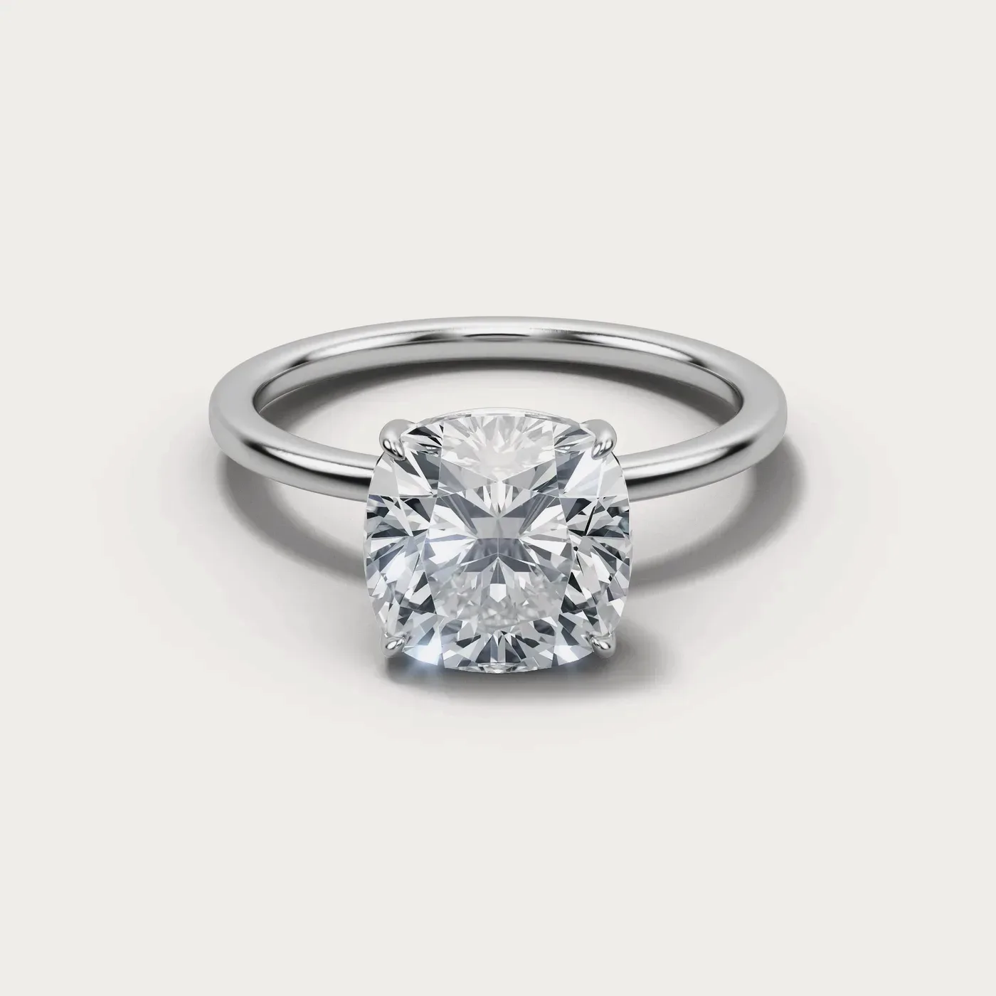A cushion square cut diamond in the same white gold solitaire, seen from directly above