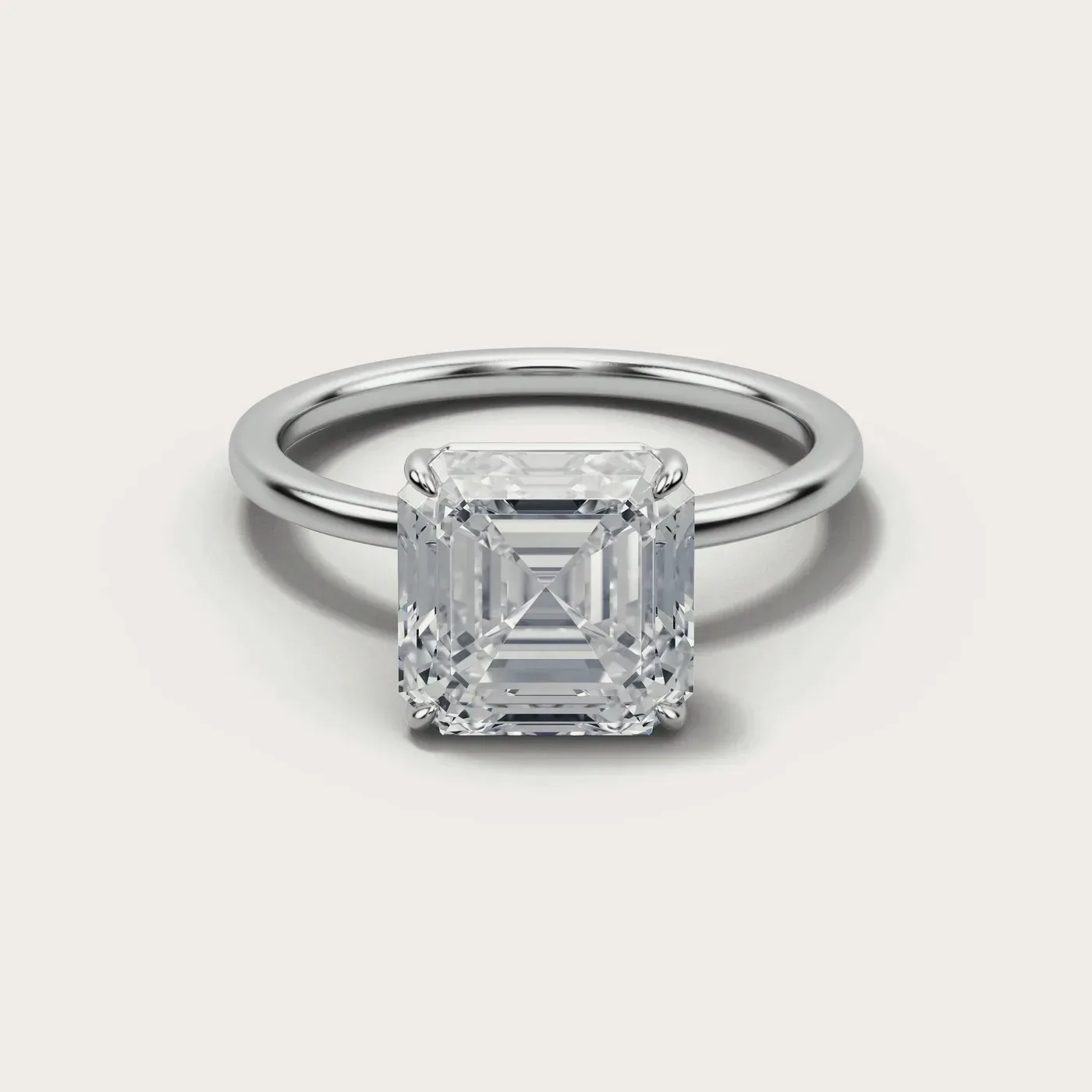 A emerald square cut diamond in the same white gold solitaire, seen from directly above