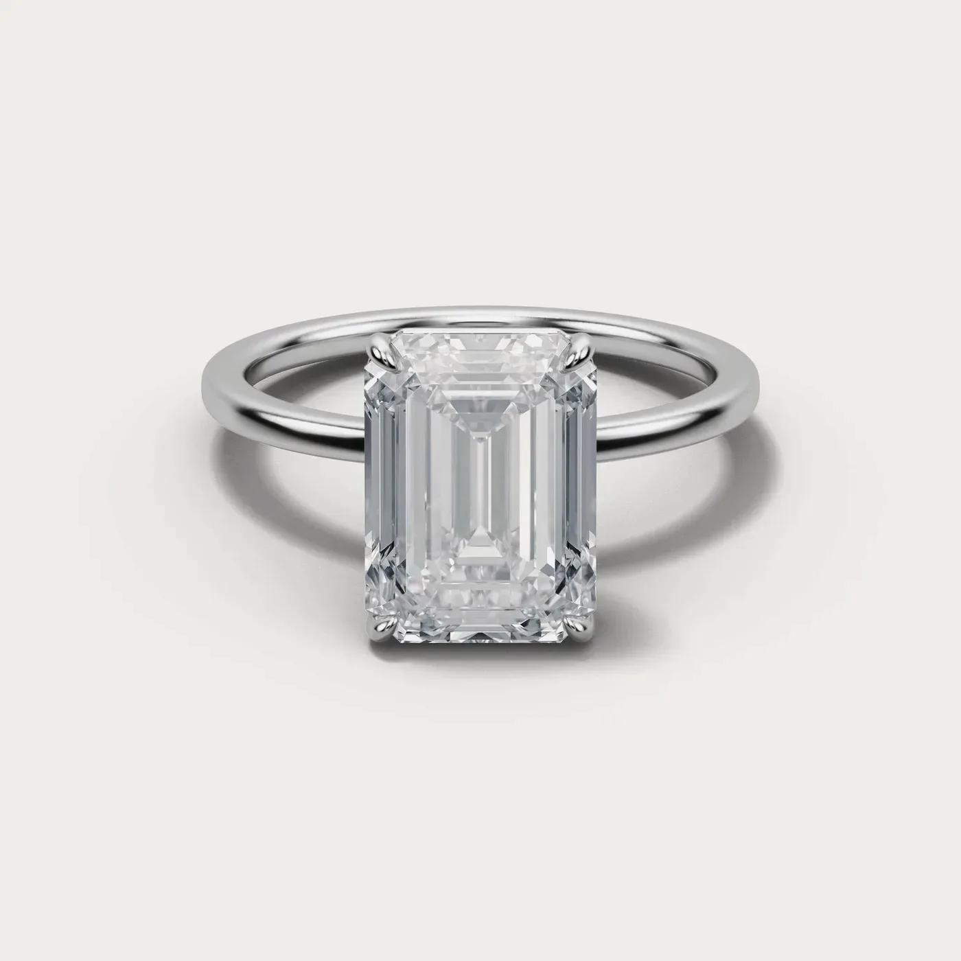 A emerald cut diamond in the same white gold solitaire, seen from directly above