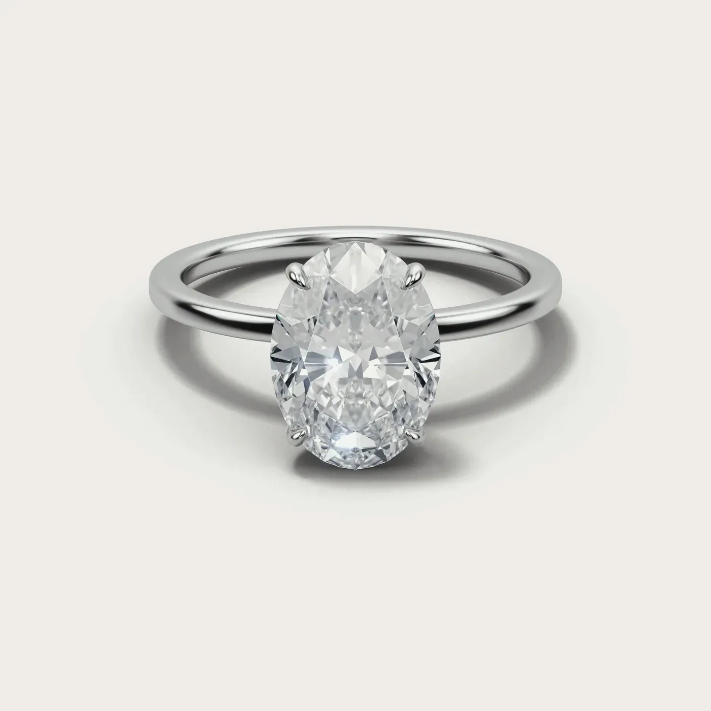 A oval cut diamond in the same white gold solitaire, seen from directly above