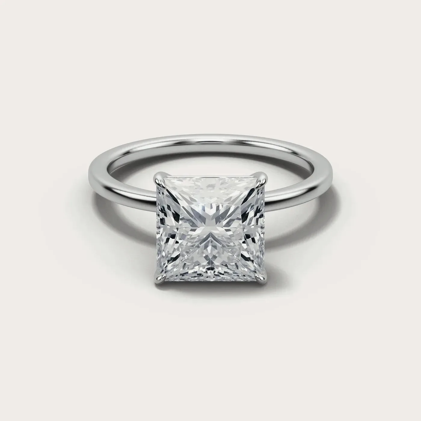 A princess cut diamond in the same white gold solitaire, seen from directly above