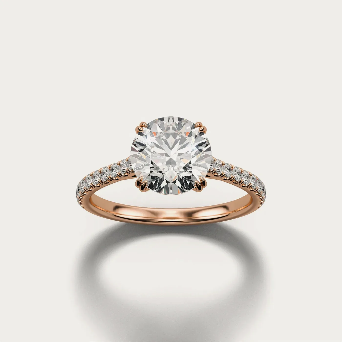A pavé solitaire in rose gold, lit and photographed identically to the other two